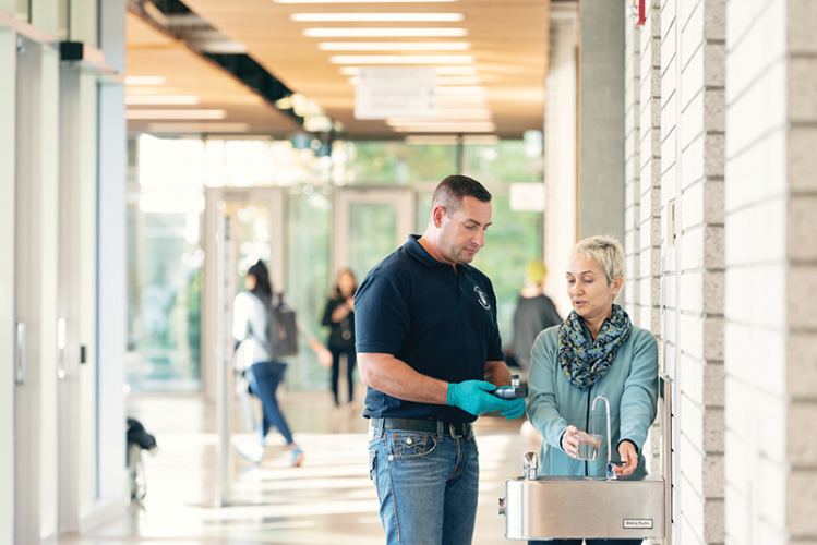 Roger Cerny and Ligia Gheorghita testing water quality at a UBC drinking fountain. Image Credit: Martin Dee / University of British Columbia.